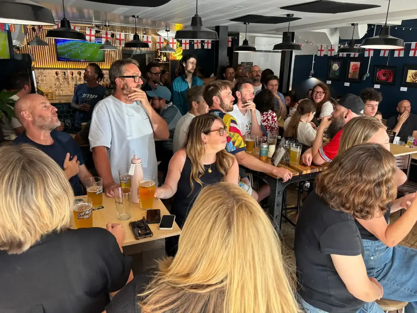 Regulars gathered around a table at Lost and Found